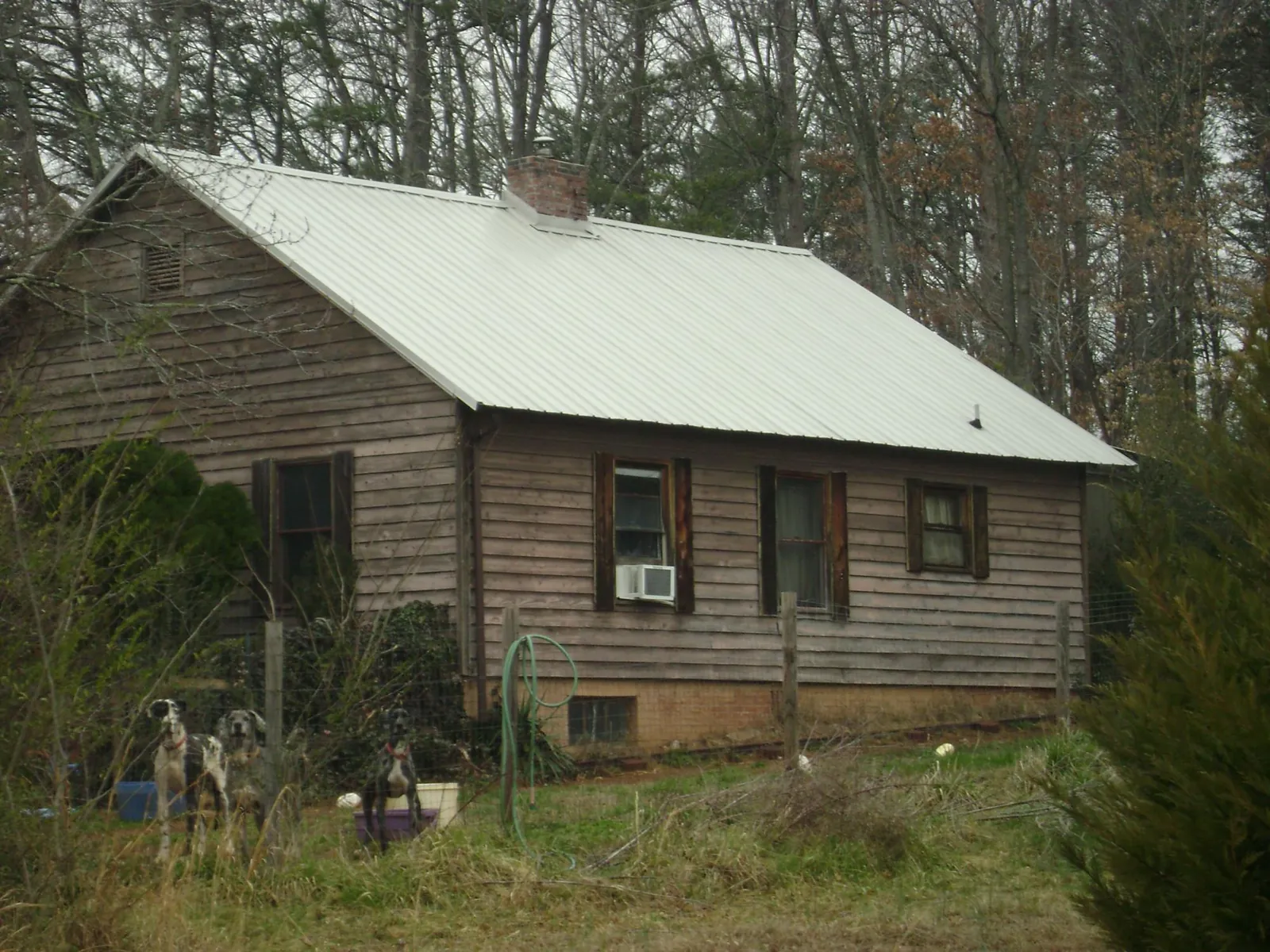 White metal roof on an old wood sided farmhouse, from a Asphalt Shingle Roof Repair job in Moscow